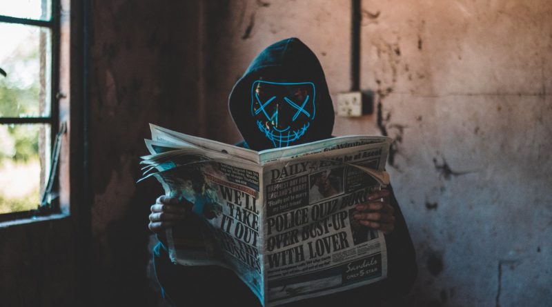 person reading newspaper inside room